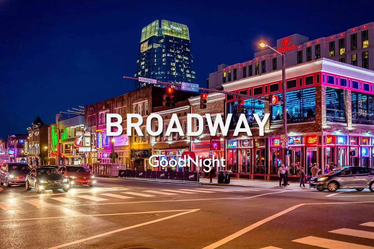 A lively downtown Nashville street illuminated by bright neon signs, bustling with people walking, cars passing, and a festive atmosphere. The energy of the city’s nightlife and live music venues is palpable.